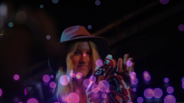 Singer raising tambourine, tapping mic and clapping, keeping beat while bokeh drifting across lens