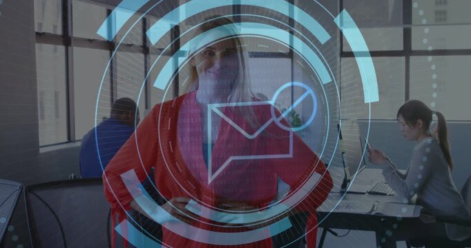 Diverse coworkers watching adult woman standing in red blouse at office with HUD rotating mail icon