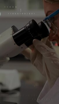 Vertical video: Gloved hand turning ocular, lab tech peering into scope, code aiding analysis