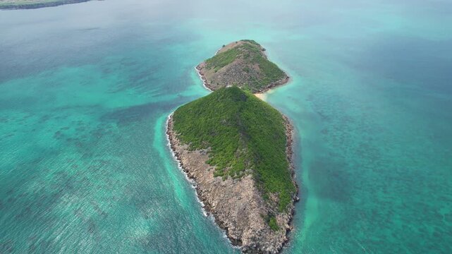 A cinematic drone shot glides toward Ilh&eacute;u das Cabras off the coast of S&atilde;o Tom&eacute;, revealing dramatic volcanic cliffs rising from vivid turquoise waters.Sao Tome,Africa
