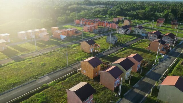 Slow cinematic pan across rooftops with morning sunlight at Camella Homes Alfonso Cavite Philippines