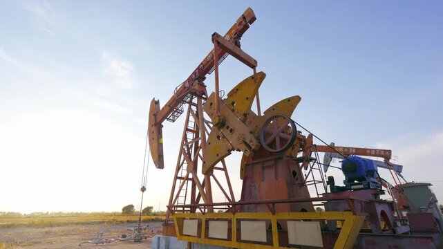 The change oil gasoline prices, petroleum crude oil drilling rigs derrick, pump jack machine oilfield work tirelessly, continuous extraction fossil fuels global energy consumption power supply crisis