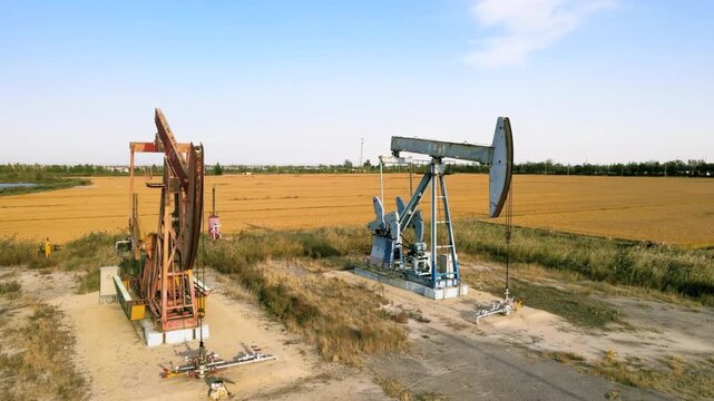 Crude oil gasoline production drilling rigs derrick, pump jack machine oilfield work tirelessly in vast, continuous extraction of fossil fuels global energy consumption power supply demand crisis