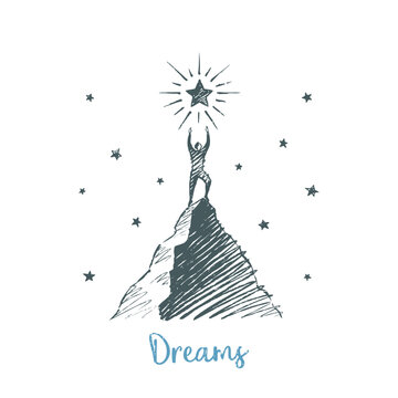 Dreams - person reaching for a shining star on a mountain