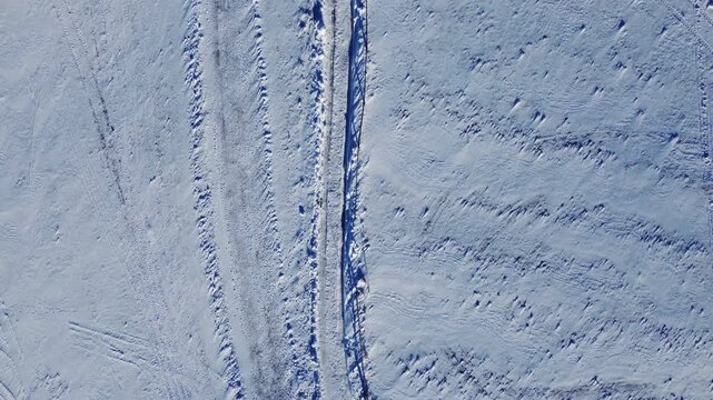 High angle shot of a trodden hiking path in deep fresh snow in Poland