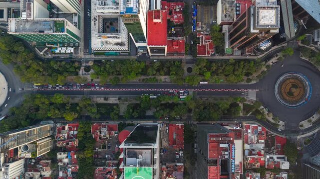 Drone top-down hyperlapse view of traffic circulating around the Angel of Independence roundabout on Paseo de la Reforma, Mexico City.