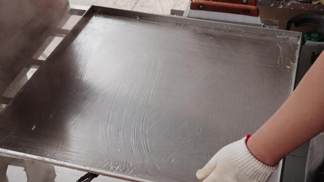 The making of stone-ground rice noodle rolls, a specialty food of Guangdong and Guangxi provinces in China