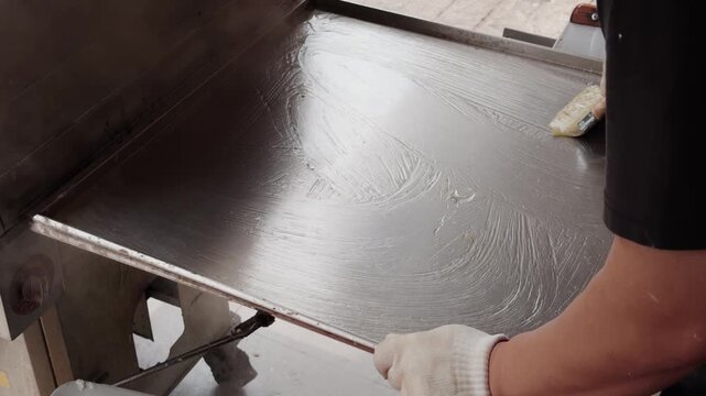 The making of stone-ground rice noodle rolls, a specialty food of Guangdong and Guangxi provinces in China