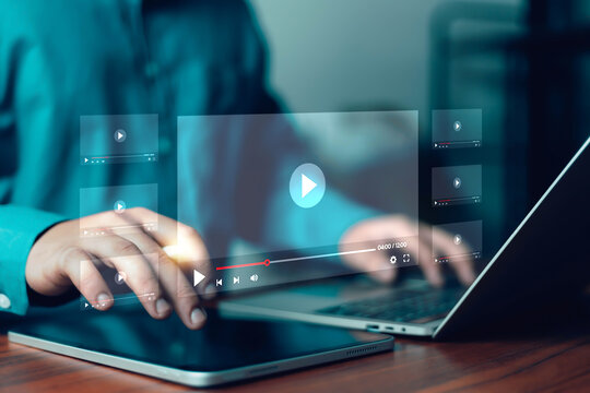 Modern digital media streaming concept showing user interacting with tablet and laptop, video player interface overlay, online content consumption, technology lifestyle, multimedia and entertainment