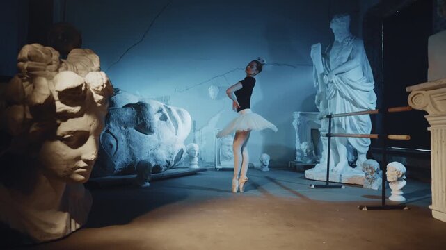 Inspired young ballerina dancing in museum between ancient statues, modern art. Graceful ballet dancer performing classical choreography, enjoy contemporary and classic arts, moving by fabulous music