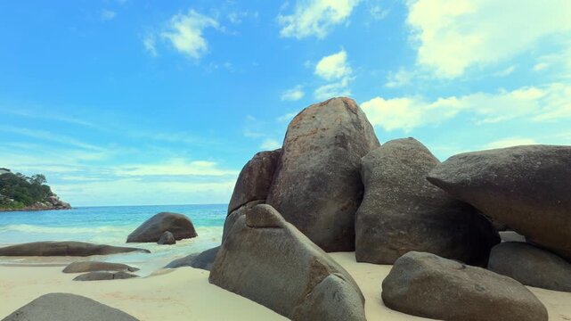 Carana beach, huge granites stones, white sandy beach with calm water, Mahe, Seychelles 25fps