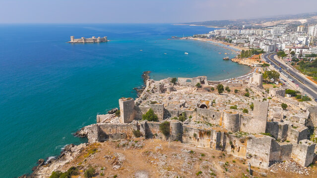 Kizkalesi, Mersin, Turkey. Aerial coastline view with sandy beaches, Maiden Castle on island and historic Korykos Castle on shore, summer.. Aerial View