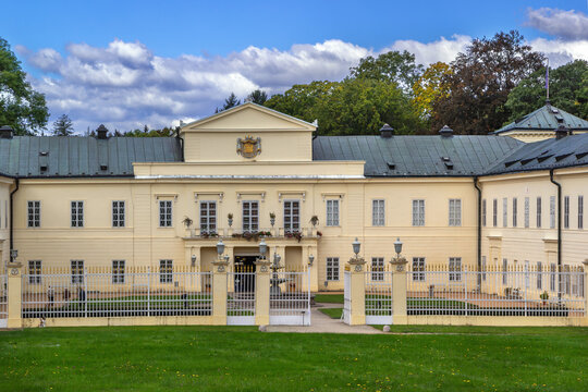 Main facade of Kynzvart Castle in Cheb District, Czech Republic. Neoclassical palace architecture under partly cloudy sky