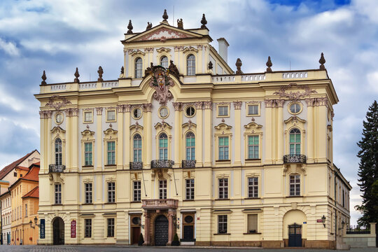 Archbishop Palace in Prague Castle district, Czech Republic. Historical rococo architecture under cloudy grey sky in Bohemia