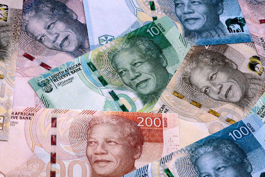 South African rand money bills pile on table. South Africa banknotes of ZAR currency close up.