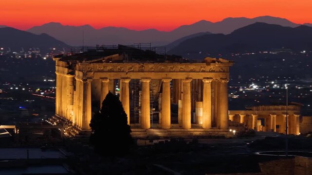 Aerial close-up view of the illuminated Parthenon Temple at the Acropolis of Athens, Greece, during evening time