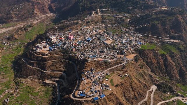 Aerial View of Dense Mountain Town and Winding Switchback Roads, 4K