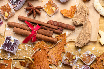 Cinnamon sticks and Turkish delight pieces with festive Christmas orange peel trees