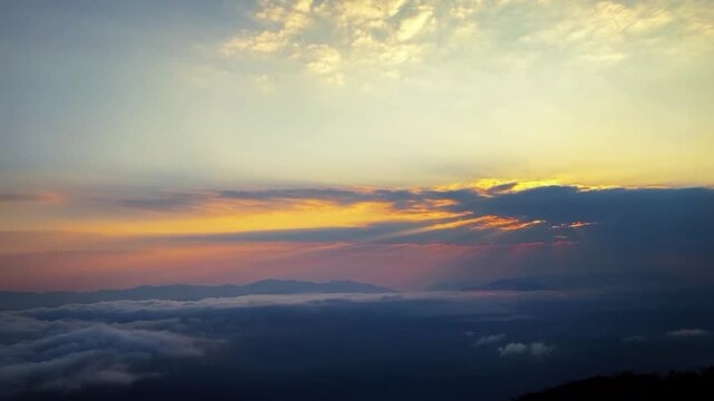 A breathtaking 1080p horizontal timelapse capturing an intense orange-red sunrise over a vast, flowing sea of clouds in Hainan, China, showcasing the majestic beauty of dawn.