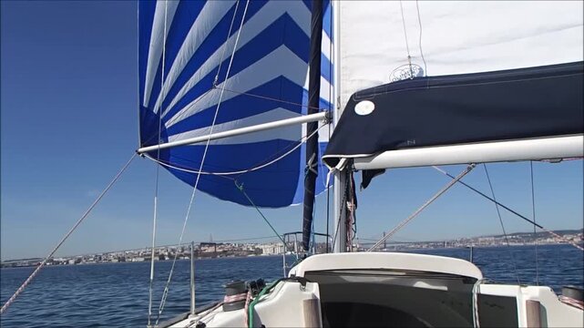 Sailing under a clear blue sky with vibrant flags waving