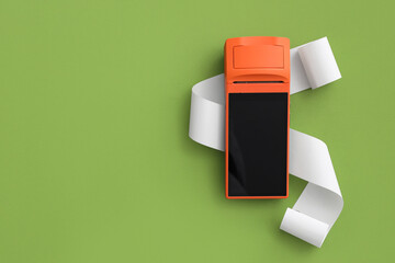Payment terminal with receipt paper on green background