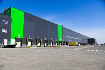 Fototapeta premium Row of loading docks warehouse building with truck.