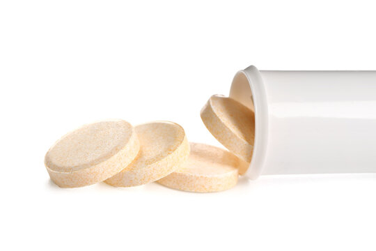 Bottle with vitamin C pills on white background
