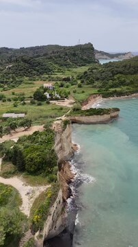 Crystal clear turquoise water at Canal d'Amour, Sidari, Corfu. High angle view of yellow sandstone rock layers and emerald Mediterranean sea. Incredible natural beauty of the Greek coast.