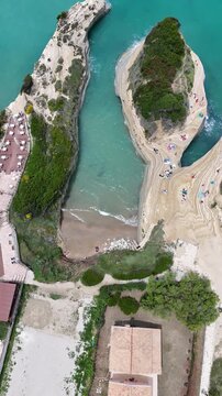 Stunning aerial view of Canal d'Amour in Sidari, Corfu. Unique sandstone rock formations, turquoise Ionian Sea water, and natural sea caves under bright summer sun in Greece.