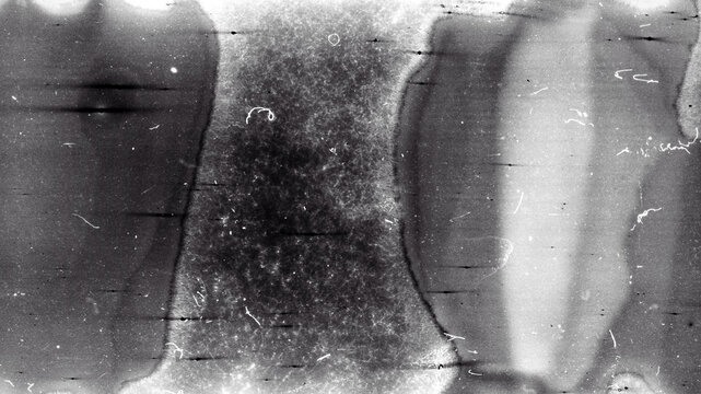 Blank grained film strip texture background with heavy grain, dust and light leak. Old expired moldy photographic film scan.