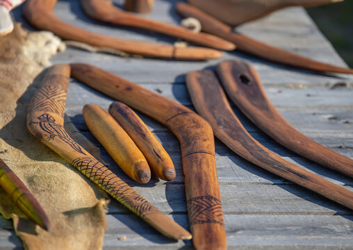 Aboriginal boomerangs and clap sticks on wooden surface traditional indigenous craft works Australia
