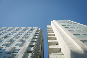 Modern commercial building architecture. Against blue sky. Low angle view. © sinseeho