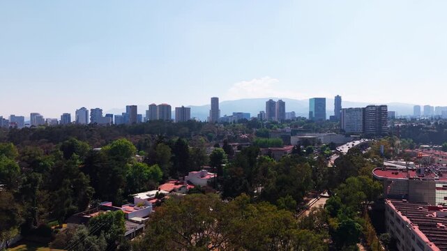 Drone Aerial rising shot of residential neighborhood and city skyline, 4K D-Log ProRes