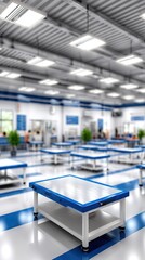 Fototapeta premium Bright office and laboratory area features large windows and white desks with blue chairs, designed for research and medical work