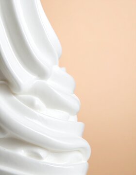 Glossy White Cream Swirl Closeup on Soft Beige Background