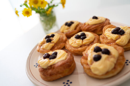 Zeppole di San Giuseppe. A traditional Italian pastry filled with custard and topped with black cherries, typically served on Father's Day. Traditional pastry.