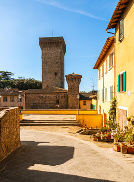 Medieval stone tower dominating town square in Lucignano Tuscany, Italy.