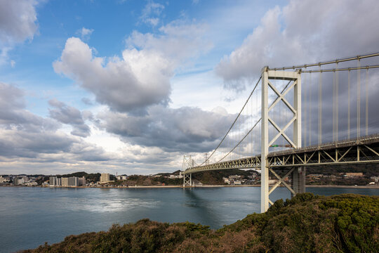 Majestic view of the Kanmon Bridge suspension structure crossing the Kanmon Straits, connecting Honshu and Kyushu islands near Kitakyushu, Fukuoka, Japan