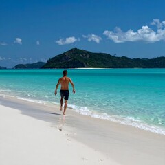 Man Running on Whitehaven Beach, Whitsunday Islands, Australia.