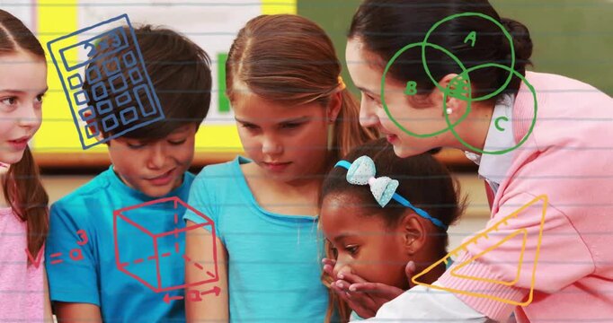 Leaning teacher in pink sweater guiding kids around silver laptop in classroom with math overlays