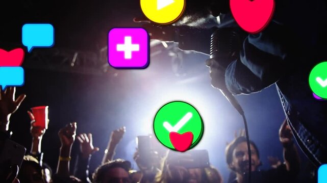 Alerts popping, jacketed singer leaning, singing into corded-mic at club, engaging fans with icons