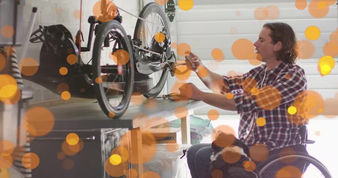 Man in wheelchair grabbing tool at bench, tightening hub bolt for repair while orange overlays pass