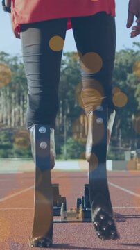 Vertical video: Teen athlete stepping aligning carbon blades into block with bokeh preparing sprint