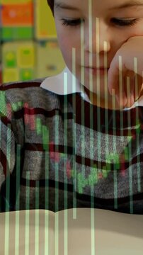 Vertical video: Pupil reaching to turn page leaning and reading green bar covering pupil for school