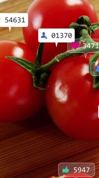 Vertical video: On posting recipe tomatoes on board attracting social icons stacking to show buzz