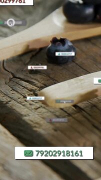 Vertical video: Berry and spoon sitting on plank, mouse clicking tag spawning mail badges for tech