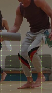 Vertical video: Yoga participants entering with mats, man placing mat, green grid overlay tracking