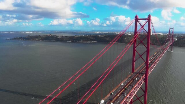 Traffic on Ponte 25 de Abril suspension bridge over Tagus river in Lisbon Portugal from aerial perspective