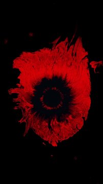 Vertical animation of a red ink drop bleeding in stop motion, ideal for horror themed social media stories