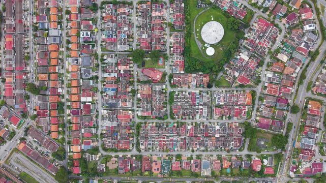 Top-down aerial view of a residential neighborhood in Petaling Jaya, Malaysia, showing urban layout, houses, streets, and green park spaces in a modern city environment.